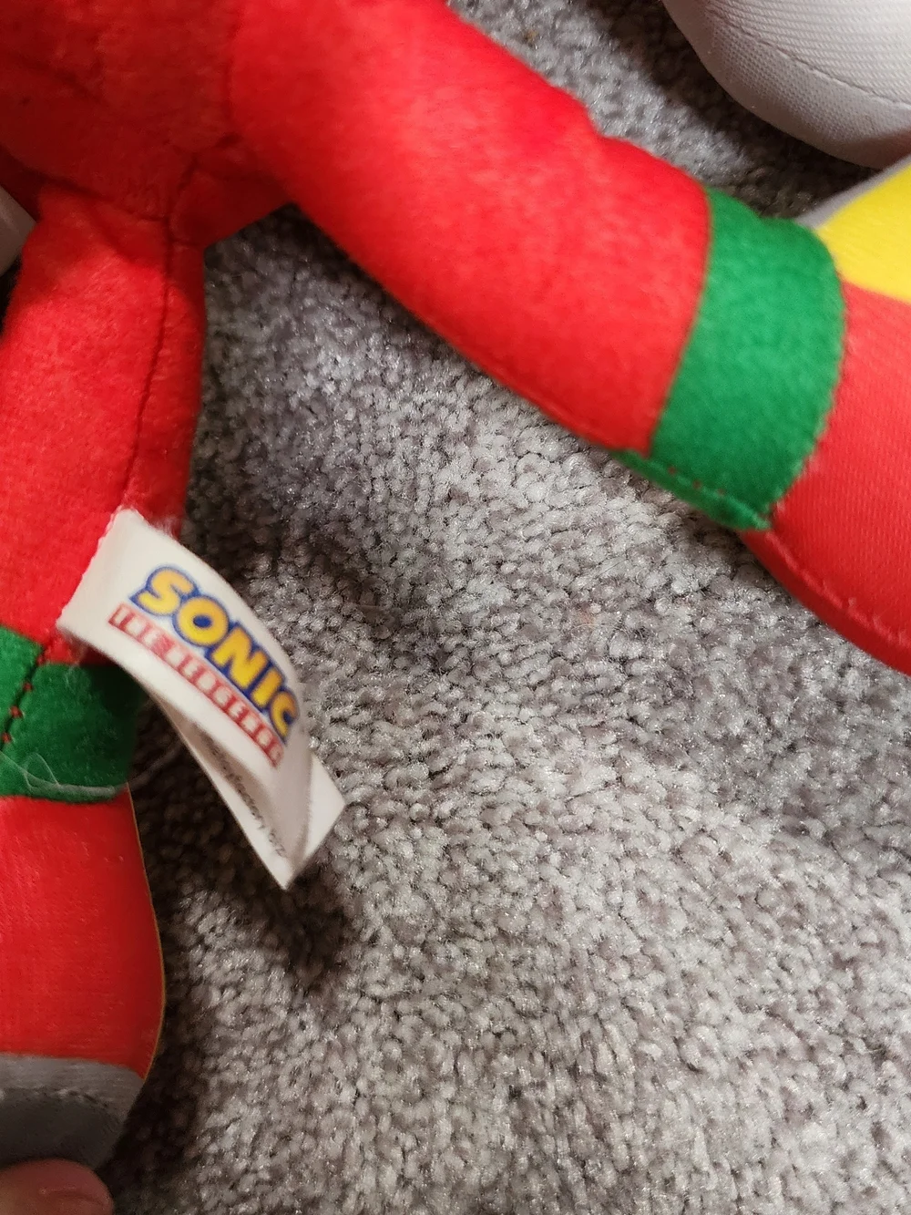 Red Plush Character Toy with White Gloves and Multicolor Shoes